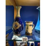 A ROYAL DOULTON BLUE AND GREEN GLAZED VASE; 26 CMS AND A ROYAL DOULTON GLAZED JUG.