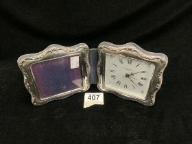 A HALLMARKED SILVER FOLDING CLOCK/PHOTO FRAME; BIRMINGHAM 1994; P J PANTON; 12.5X13 CMS.