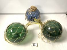 THREE VINTAGE GREEN GLASS FISHING FLOATS.