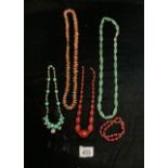 TWO CHERRY COLOURED BEAD NECKLACES, TWO GREEN HARDSTONE NECKLACES AND ANOTHER.