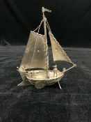 A HALLMARKED SILVER MODEL OF A SAILING BOAT AND SAILORS; SHEFFIELD 1898 (IMPORTED); MAKER SAMUEL