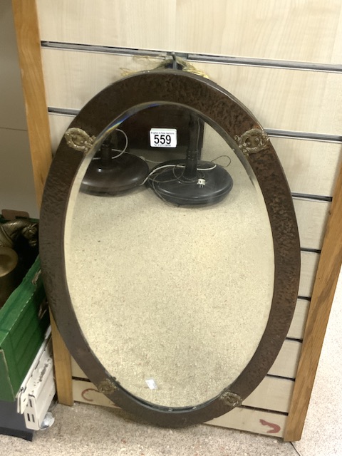 ARTS AND CRAFTS OVAL BEVELLED WALL MIRROR WITH BEATEN COPPER FRAME; 44X75 CMS.