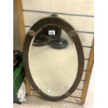 ARTS AND CRAFTS OVAL BEVELLED WALL MIRROR WITH BEATEN COPPER FRAME; 44X75 CMS.
