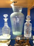 TALL GLASS VASE; 36 CMS AND TWO GLASS DECANTERS.
