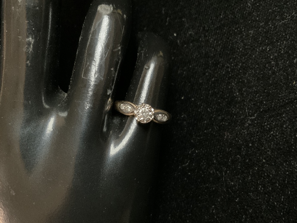 A 9CT HALLMARKED GOLD SOLITAIRE DIAMOND RING AND DIAMONDS IN SHOULDERS; SIZE J1/2; 2.1 GMS.