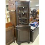 A MAHOGANY ASTRAGAL GLAZED CORNER CABINET WITH BLIND FRET DECORATION.