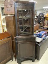 A MAHOGANY ASTRAGAL GLAZED CORNER CABINET WITH BLIND FRET DECORATION.