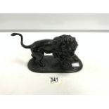 A BRONZE EFFECT SPELTER FIGURE OF A LION AND SNAKE; 25X13 CMS.