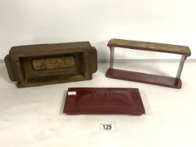 A TWO VINTAGE RED PAINTED IRON BRICK MOULDS.