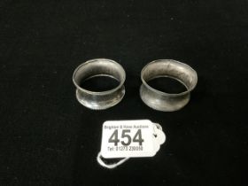 TWO HALLMARKED SILVER NAPKIN RINGS; 12 GMS.