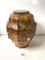 A CHINESE OCTAGONAL WOODEN FOOD CONTAINER WITH GOLD LACQUERED FIGURE AND FLOWER DECORATION; 36 CMS.