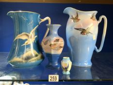 TWO WATER JUGS DECORATED WITH SEAGULLS AND OTHER BIRDS AND TWO VASES.