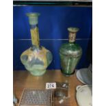 SHAPED GLASS DECANTER WITH ENAMELLED DECORATION AND GREEN GLASS DECANTER.