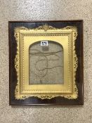 ORNATE GILT PICTURE FRAME, IN A GLAZED MAHOGANY FRAME; 37X43 CMS.