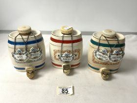 THREE WADE PORCELAIN SHERRY BARRELS AND FIVE CROWN STAFFORDSHIRE PORCELAIN DECANTER LABELS.