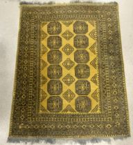 A YELLOW GROUND WOOLLEN BOKHARA RUG; 224X176 CMS.