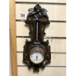 A SMALL CARVED BLACK FOREST BAROMETER.