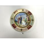 VIENNA PORCELAIN WALL PLATE DECORATED WITH MAIDENS AND PUTTI, AND GILDED; 37 CMS DIAMETER.