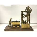 BRASS MODEL OF A COAL MINER AND PULLEY; 28x33 CMS.