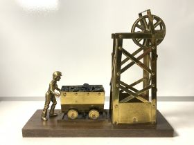 BRASS MODEL OF A COAL MINER AND PULLEY; 28x33 CMS.