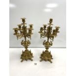 A PAIR OF ORNATE BRASS FIVE-BRANCH CANDLEABRA, (1 SCONCE MISSING ] 46 CM.