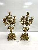 A PAIR OF ORNATE BRASS FIVE-BRANCH CANDLEABRA, (1 SCONCE MISSING ] 46 CM.