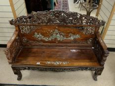 AN EARLY 19TH-CENTURY CHINESE CARVED HARDWOOD BENCH SEAT WITH DRAGON DECORATION AND MOTHER OF