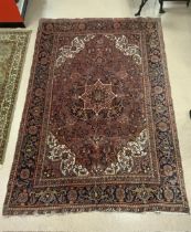 A RED GROUND PERSIAN WOOLLEN CARPET, (SOME WEAR), 334X234 CMS.