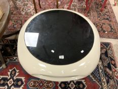 A UFO DESIGN PLASTIC COFFEE TABLE WITH SMOKED GLASS INSET TOP, 90 CMS DIAMETER.
