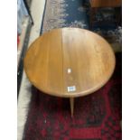 A SMALL BLONDE ERCOL DROP LEAF COFFEE TABLE.