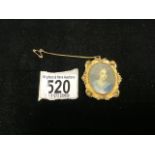 A GILT METAL OVAL BROOCH INSET WITH HANDPAINTED MINIATURE OF A YOUNG GIRL.