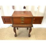 A GEORGE BUTLER PART CANTEEN OF CUTLERY IN MAHOGANY CABINET AND STAND.