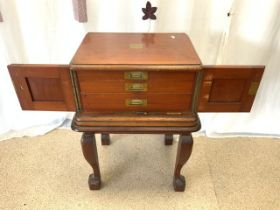 A GEORGE BUTLER PART CANTEEN OF CUTLERY IN MAHOGANY CABINET AND STAND.