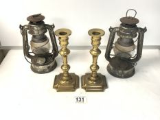 A PAIR GERMAN MADE METAL OIL LAMPS, AND PAIR BRASS CANDLSTICKS.