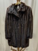 A BROWN FUR COAT BY GROSVENOR FOR HARRODS.