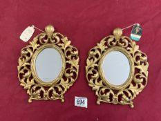 A SMALL PAIR OF ROCOCO STYLE GILT METAL WALL MIRRORS - BY PEERART.