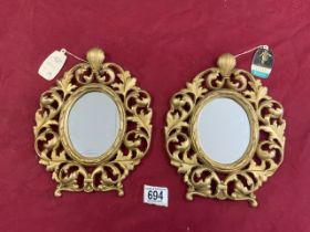 A SMALL PAIR OF ROCOCO STYLE GILT METAL WALL MIRRORS - BY PEERART.
