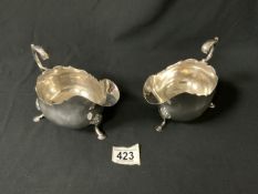 PAIR OF LARGE VICTORIAN HALLMARKED SILVER OVAL SAUCEBOATS WITH SCROLL HANDLES RAISED ON HOOF FEET;