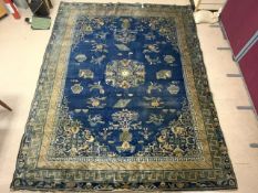 A 1930S ART DECO BLUE GROUND CHINESE CARPET, BUDDHIST SYMBOLISM PATTERNED, 11X9 FOOT.