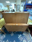 A MID-CENTURY TEAK THREE DRAWER BUREAU.