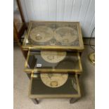 VINTAGE NEST OF TABLES WITH OLD MAPS OF THE WORLD AND BRASS SURROUND