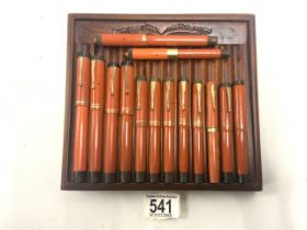 FOURTEEN ORANGE PARKER PENS WITH GOLD NIBS.