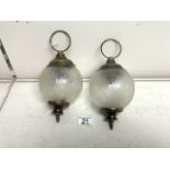 TWO SMALL METAL AND GLASS GLOBE HANGING LIGHTS.