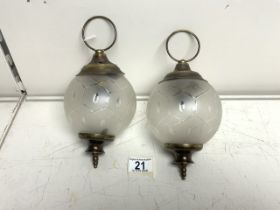 TWO SMALL METAL AND GLASS GLOBE HANGING LIGHTS.