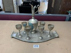 EASTERN WHITE METAL WINE EWER AND CUPS ON TRAY.