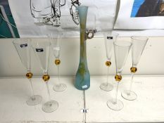 A SET OF SIX TALL GLASS CHAMPAGNE FLUTES BY LEONARDO; 30 CMS AND A TURQUOISE GLASS JUG DECORATED