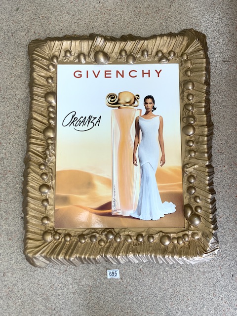 A GIVENCHY ORGANZA PARFUME ADVERTISING PICTURE IN GOLD FRAME.