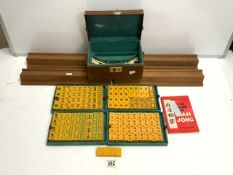 MAH JONG SET IN LEATHER CASE WITH WOODEN PIECE STANDS.