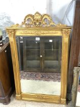 A REGENCY STYLE GILT FRAMED CHIMNEY MIRROR, 66X106 CMS.