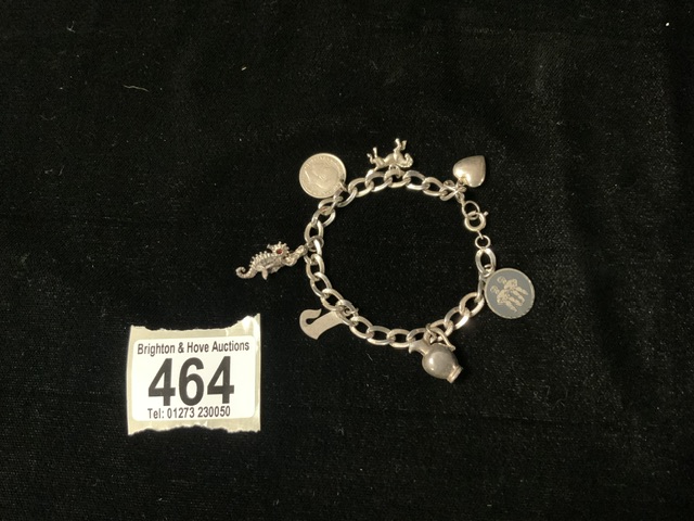 A SILVER CHARM BRACELET AND CHARMS.